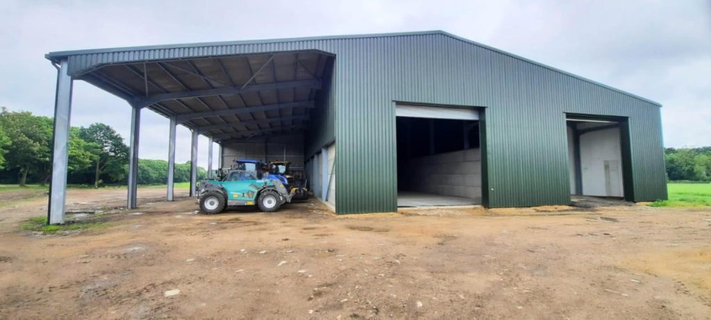 One of our previous agricultural projects, a large store shed with 2 roller shutters and open-fronted overhang for vehicle storage.