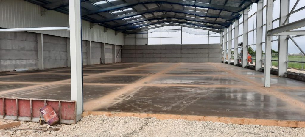 Agricultural barn with concrete floor in construction